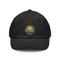 Retro wanderlust badge design on a Wander Wild Co vintage dad cap